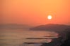黄砂に煙る夕日